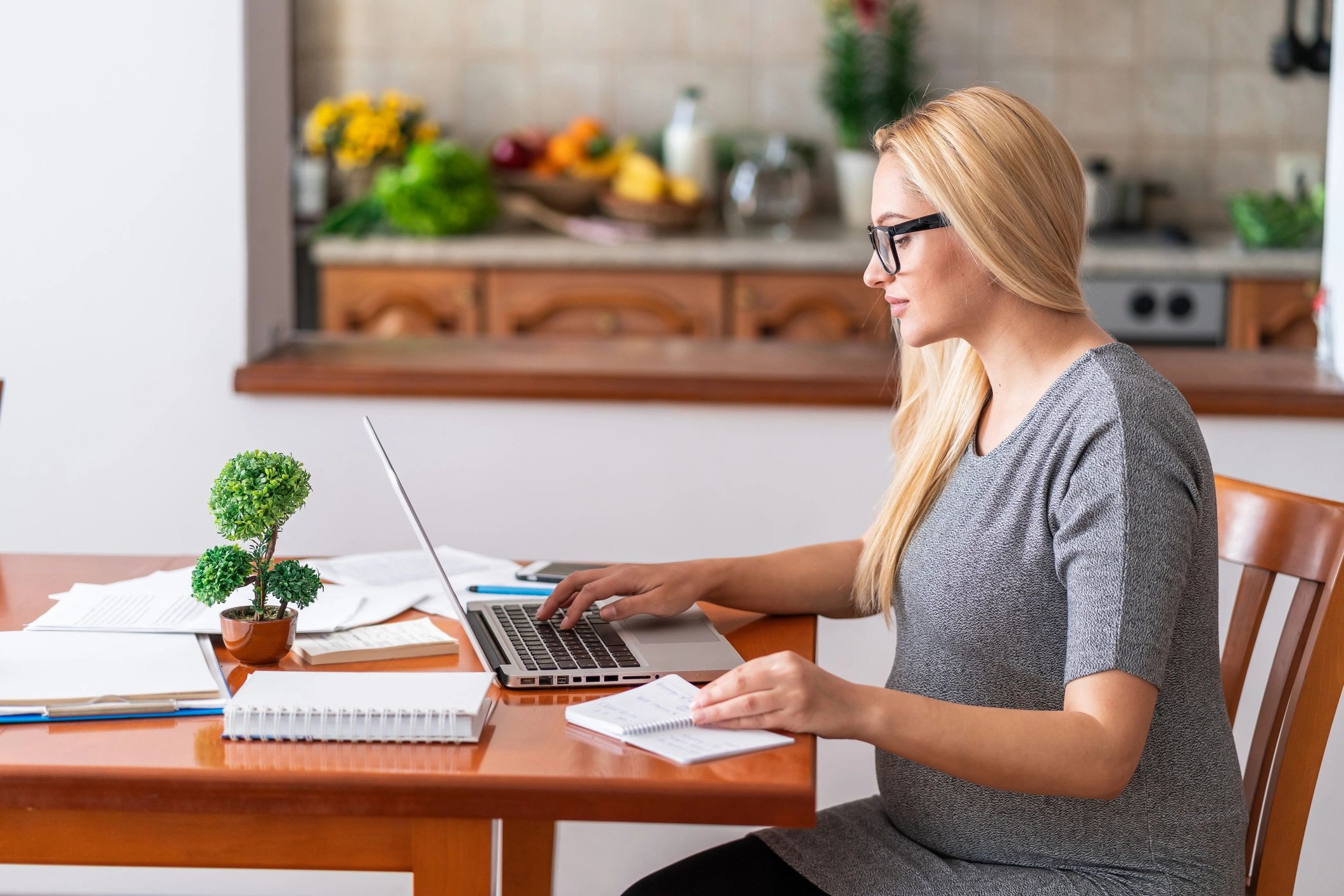 Mom working at a home desk, candid and relatable