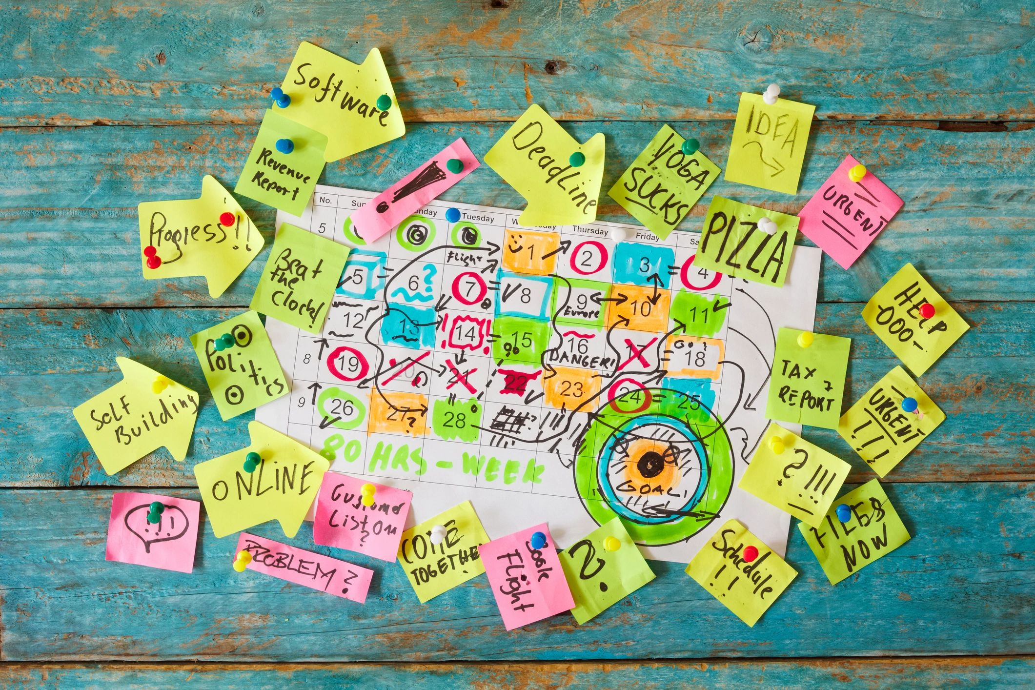 Wall calendar and sticky notes representing a busy family schedule