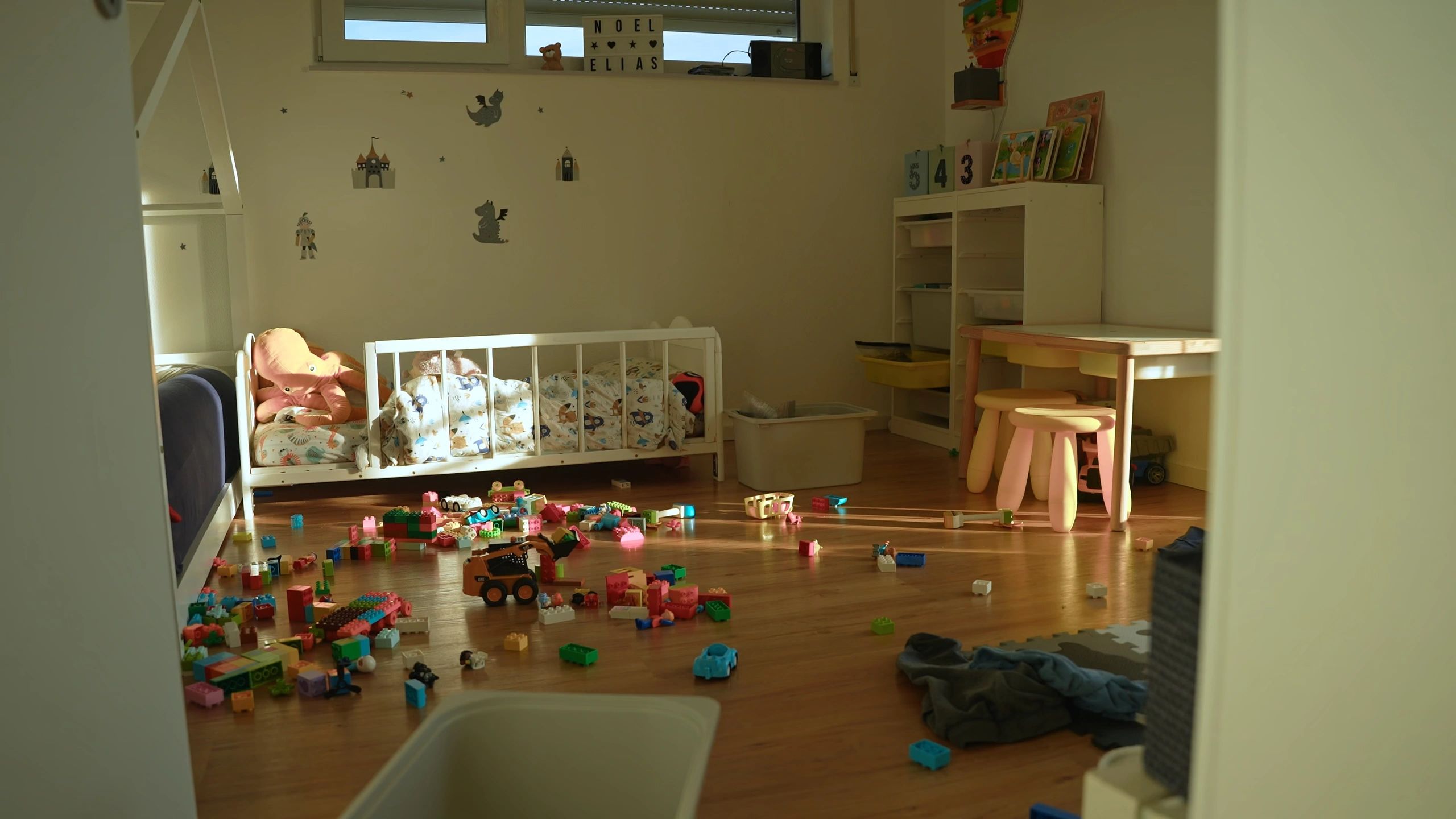 Messy playroom with toys scattered on the floor